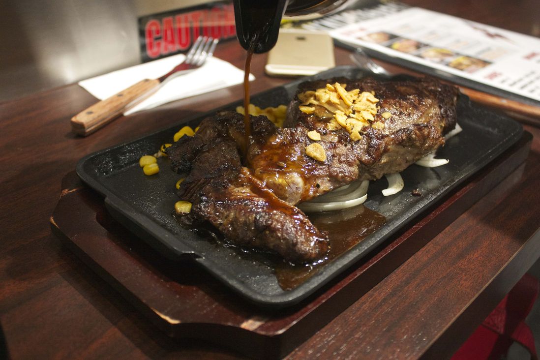 Be careful pouring over the J Sauce, as the sizzling steak spatters it everywhere<br>